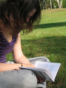 Girl reading a book outside