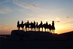 Cowboys silhouetted against sunset; image by Donna Hyora on StockExchange